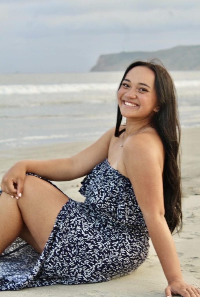 Mareta Sagapolutele, Frederick High graduate, smiling while sitting on the beach