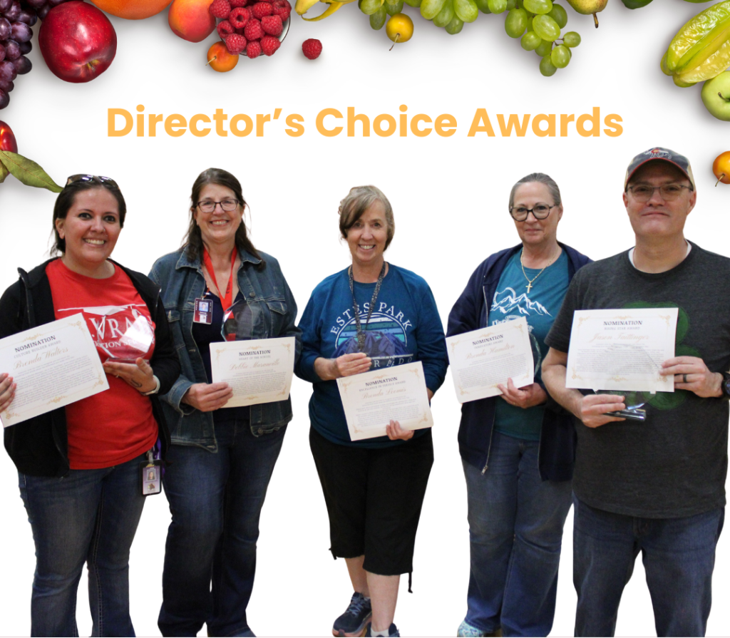 Five people hold award certificates at the Director's Choice Awards, surrounded by colorful fruit graphics.